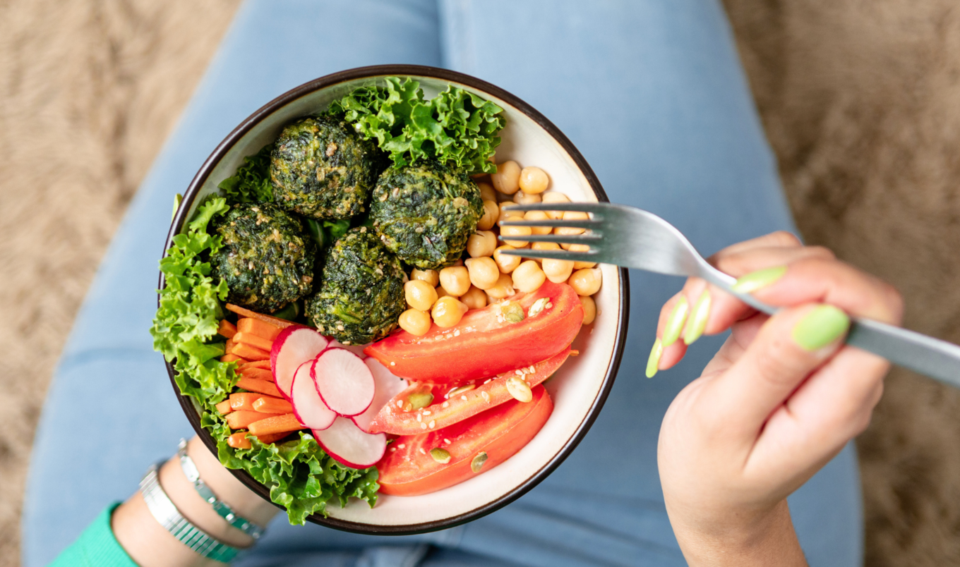 person with healthy meal on lap